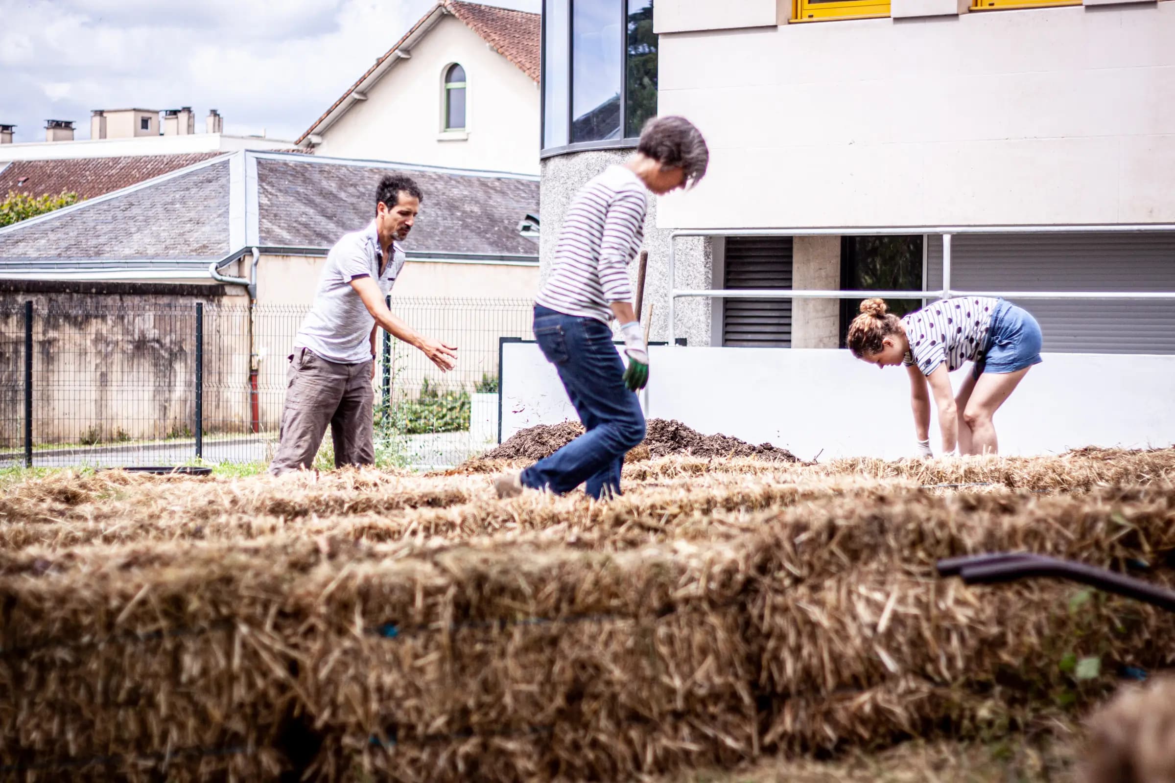 Atelier de plantation communautaire avec Les Incroyables Comestibles, citoyens plantant ensemble dans un espace vert urbain